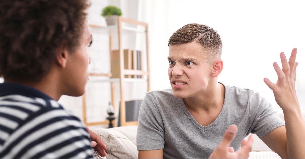 two angry friends arguing in the living room at home