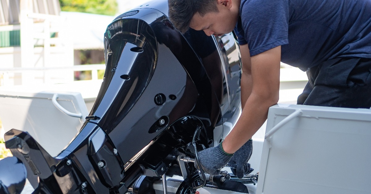 mechanic is installing speed boat engine