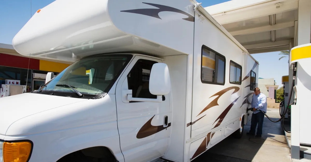 man refueling an rv at gas station