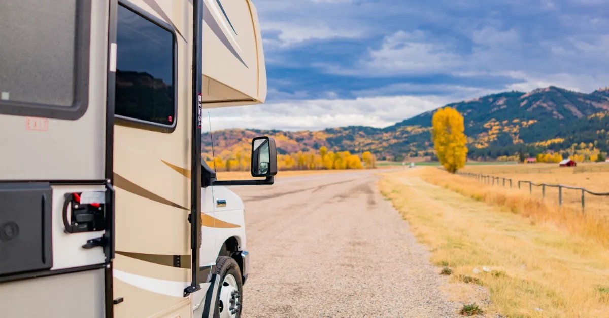 an rv on road during autumn
