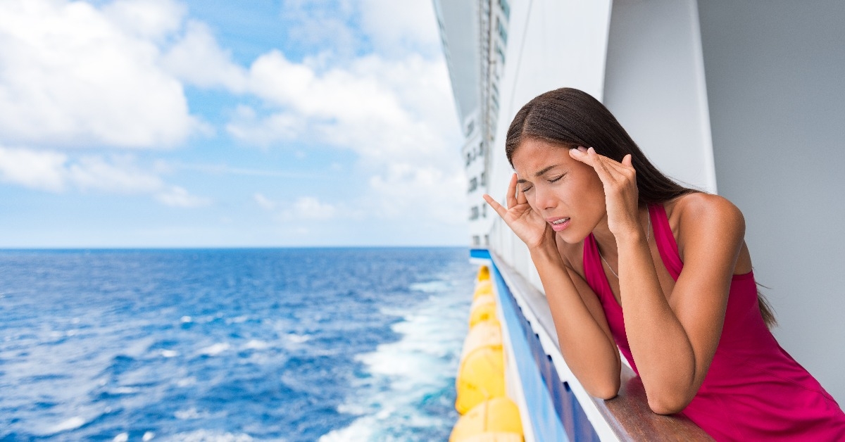 tourist woman seasick on boat vacation with headache