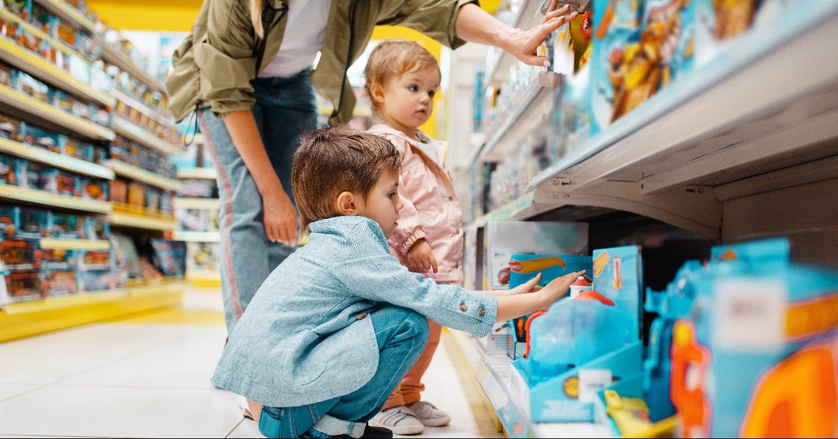 mother with her children at the shelf in store