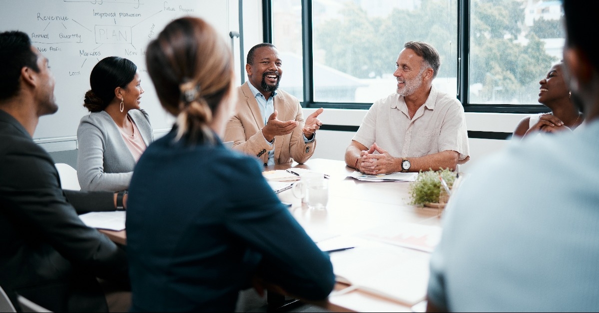 businesspeople listening to a colleagues ideas during a meeting