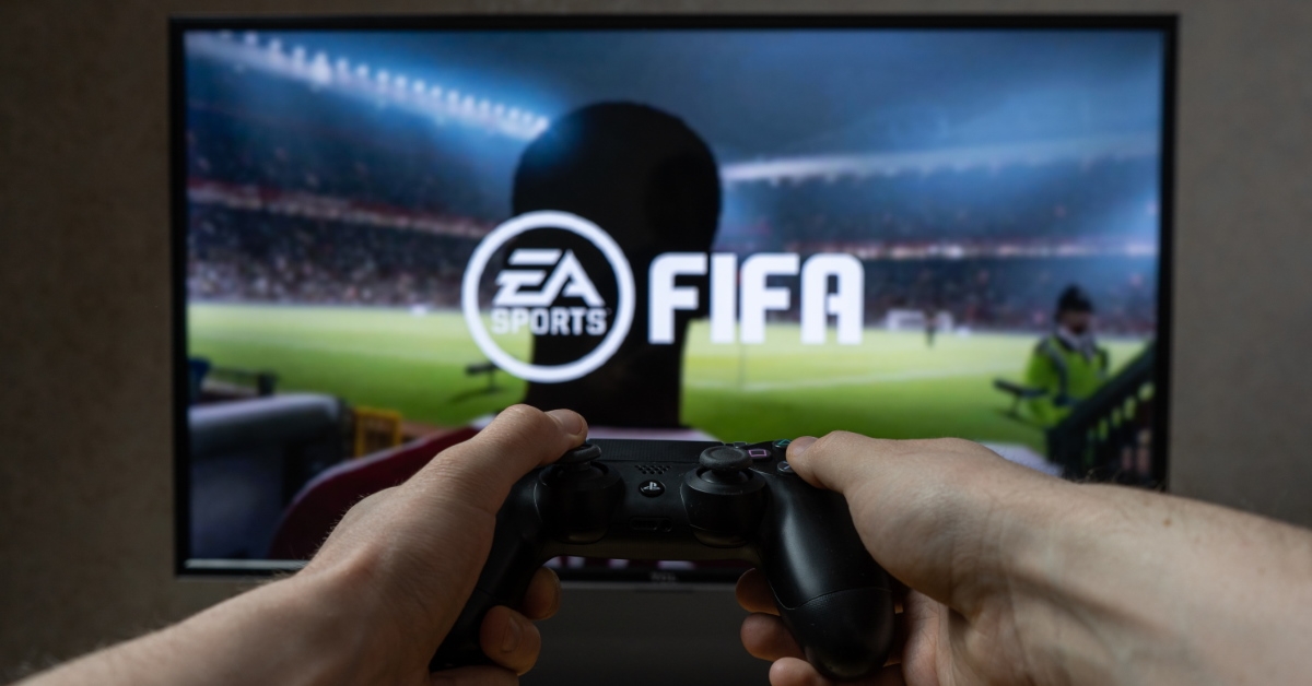 man playing fifa football game on playstation 