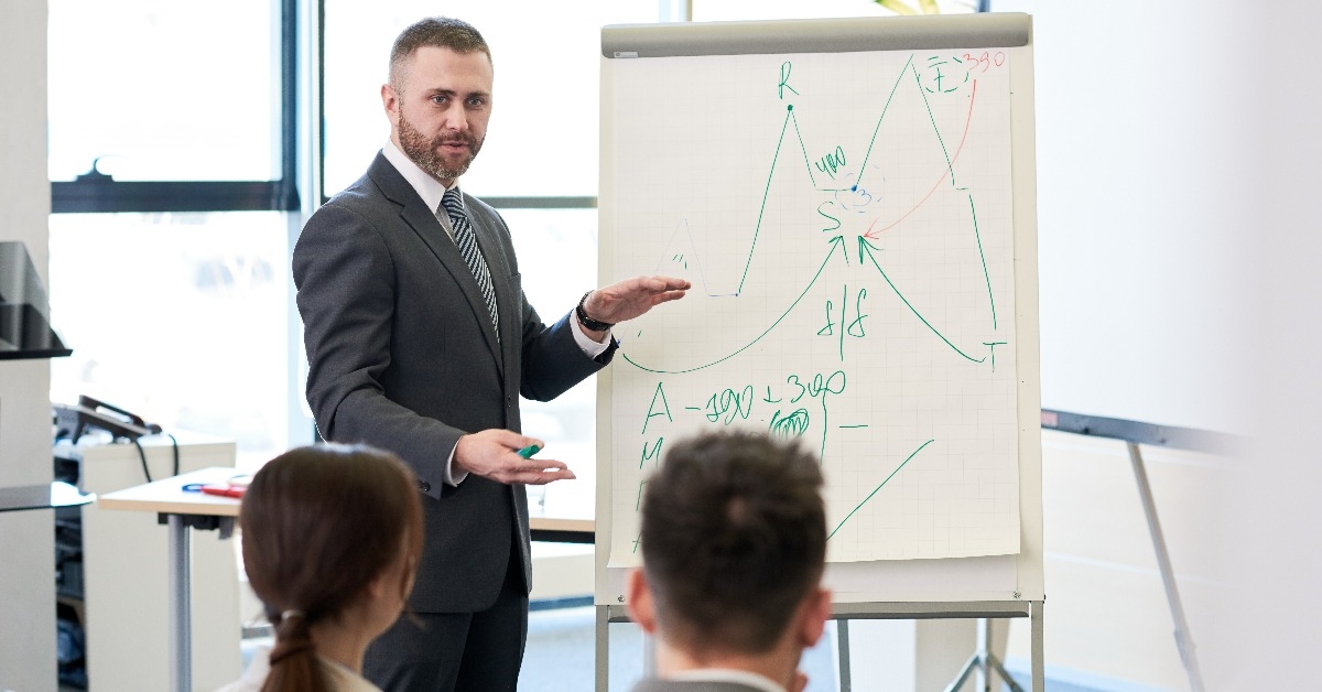 bearded business coach giving presentation for audience