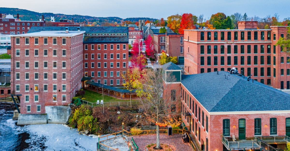shot of various buildings of red bricks having beside red and yellow trees in new hampshire during autumn