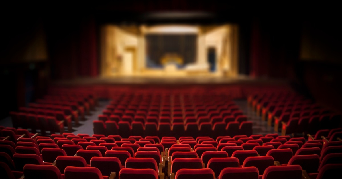 empty red armchairs of a theater ready for a show