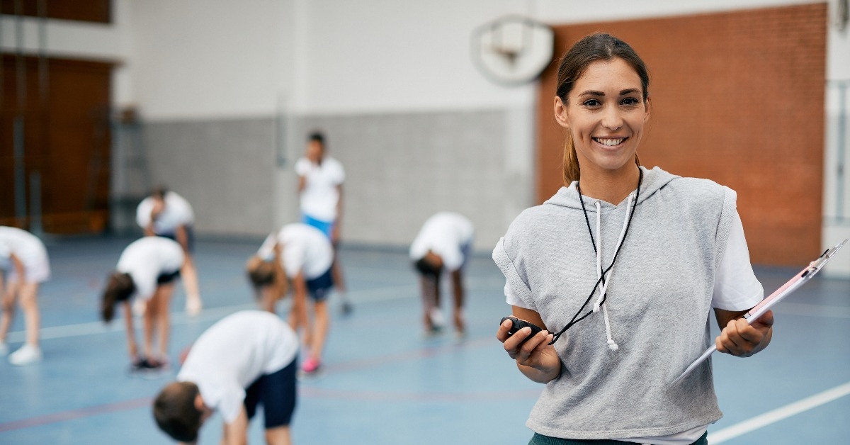 female physical education teacher at school gym