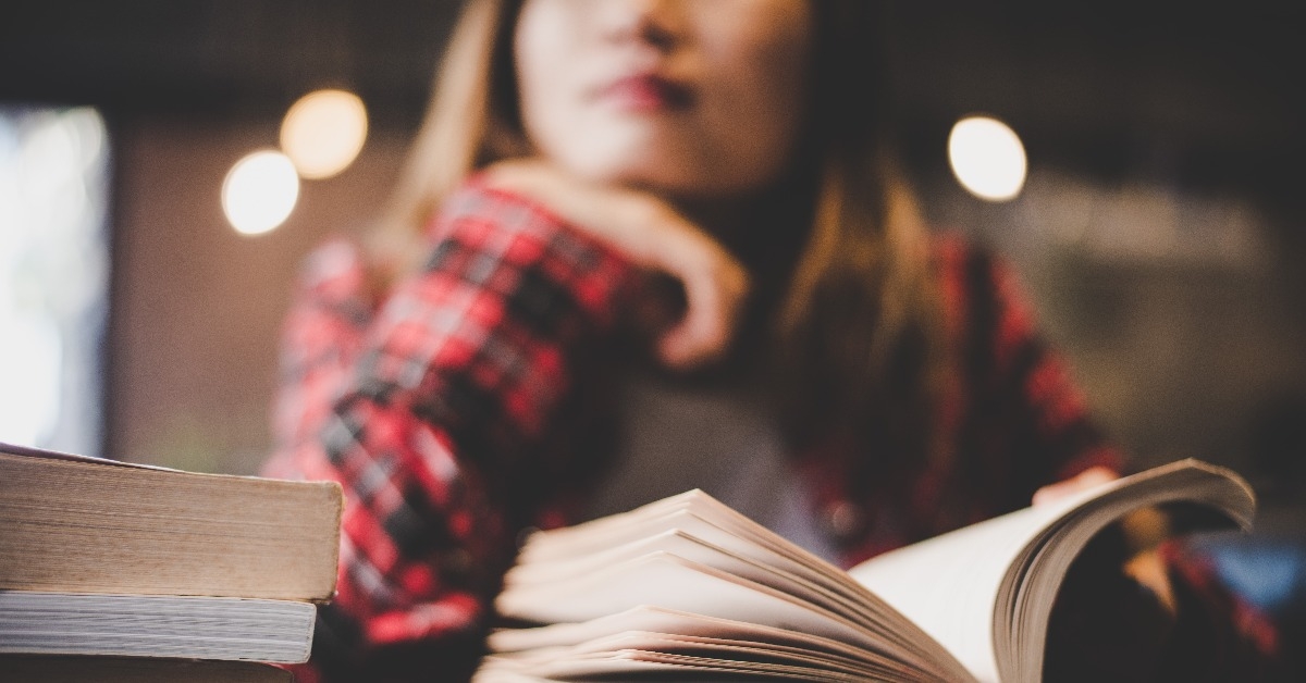 woman reading book at cafe