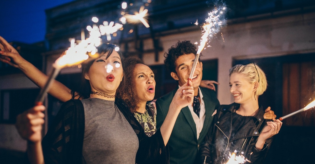 young people enjoying new years eve with fireworks
