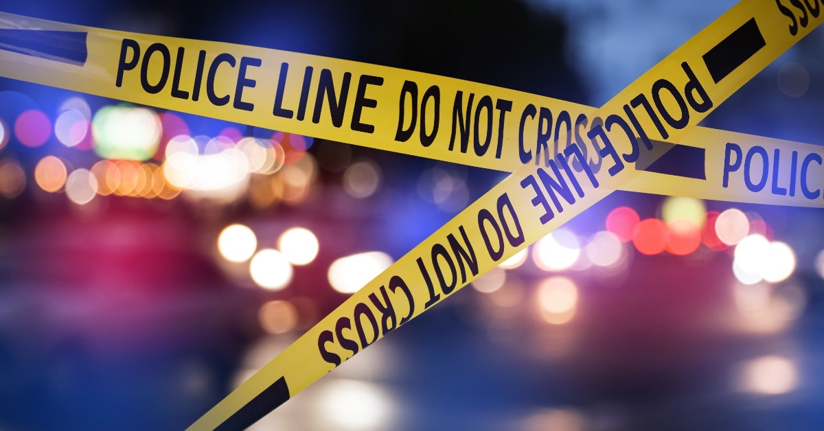 yellow law enforcement tape isolating crime scene