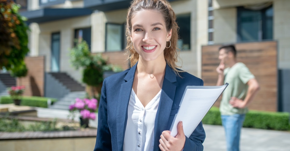 beautiful businesswoman holding documents outdoors