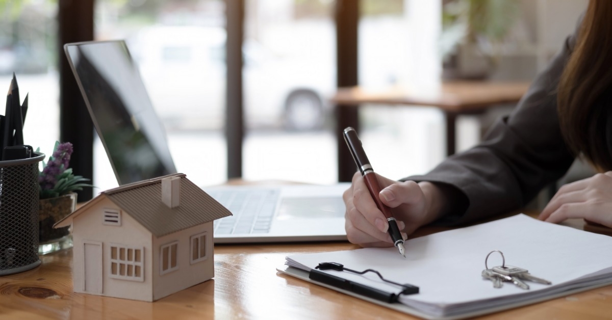 property consultant writing thoughts on paper