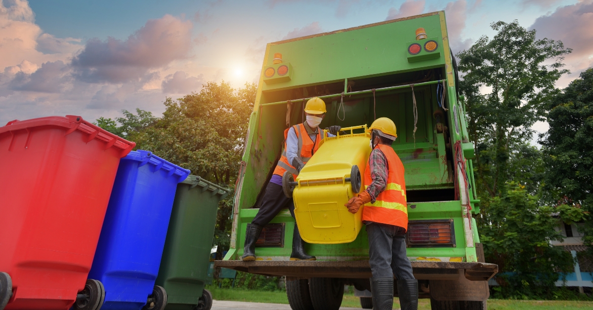 garbagemen working together on emptying dustbins