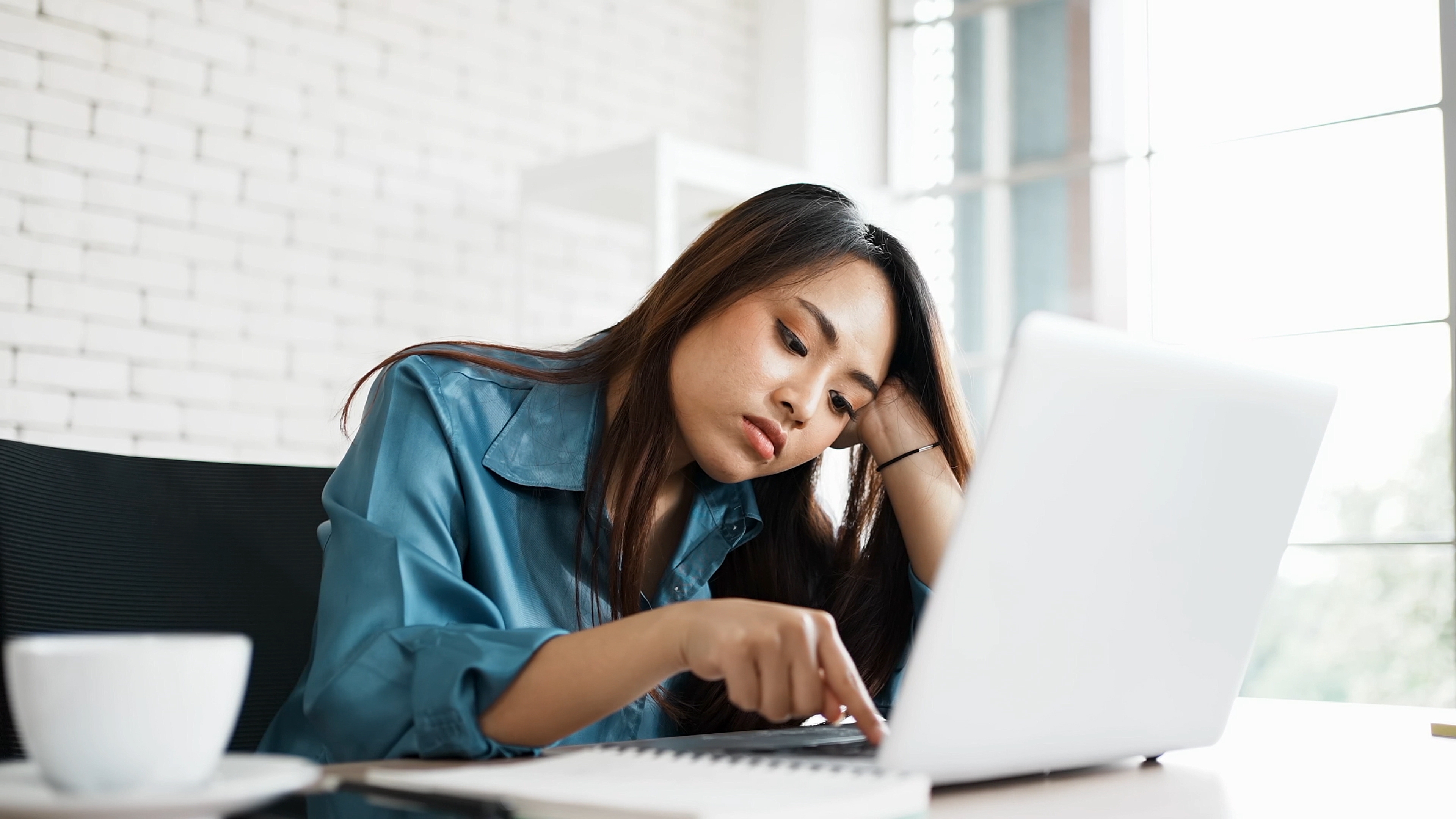 lazy asian woman holding using laptop