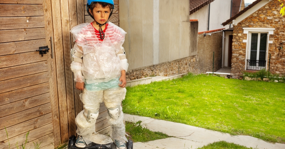sad hoverboard boy in overprotective bubble wrap