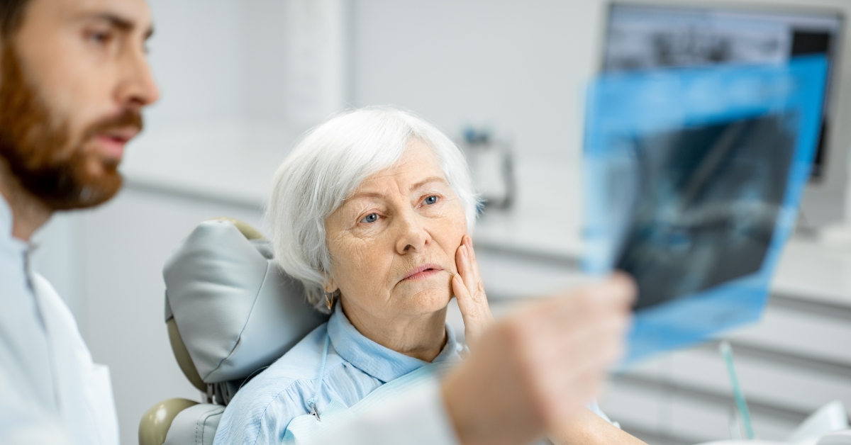worried elder woman during the consultation with the dentist
