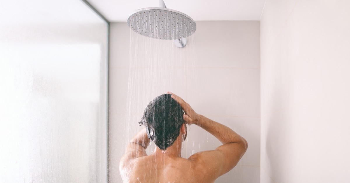 young man taking shower