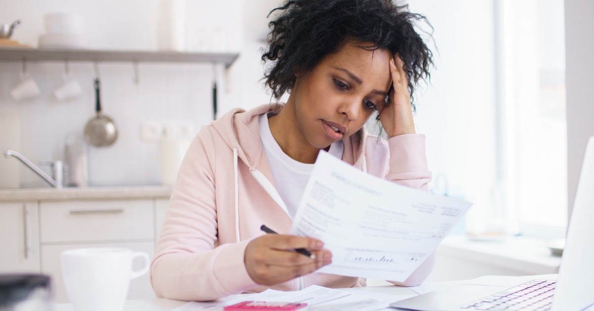 stressed african american woman looking at documents