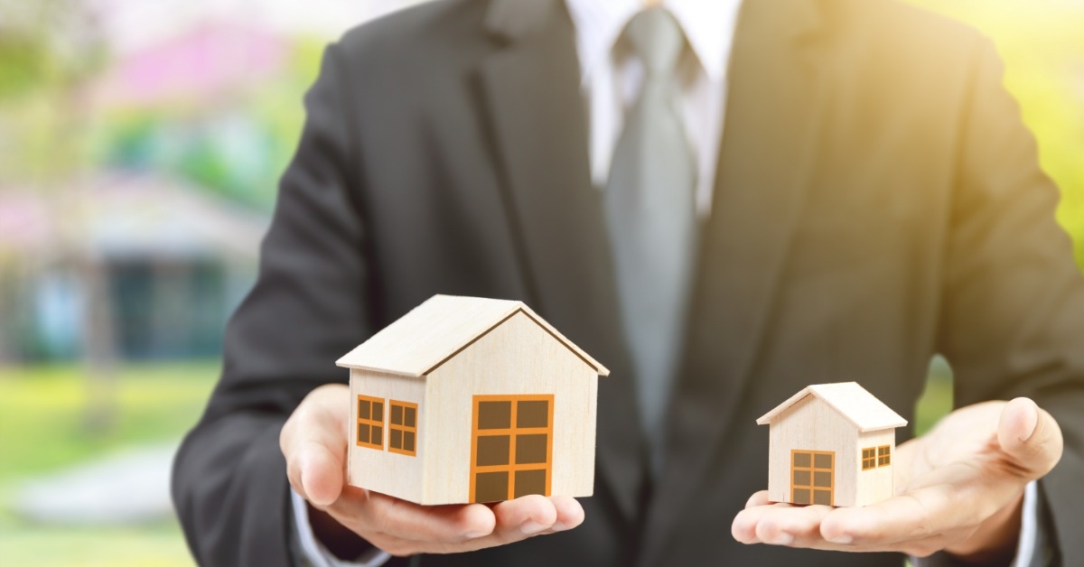 holding big and small house models