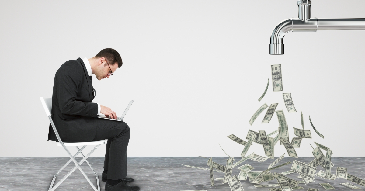 businessman working opposite flow of dollars from the faucet