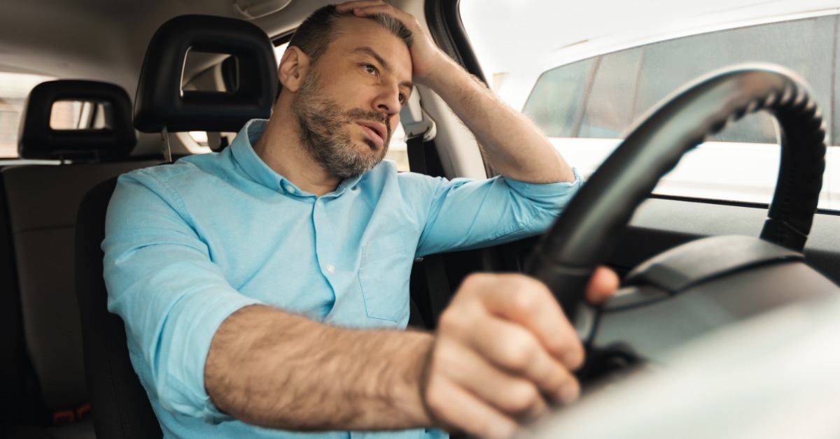 man upset while driving a car