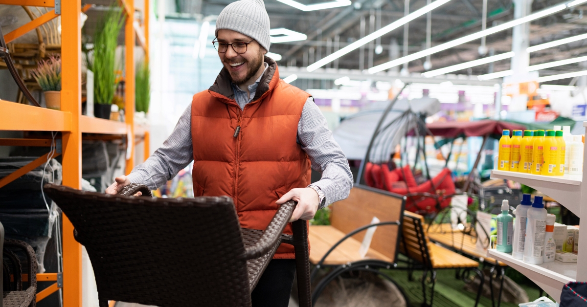 man chooses garden furniture in a hardware store