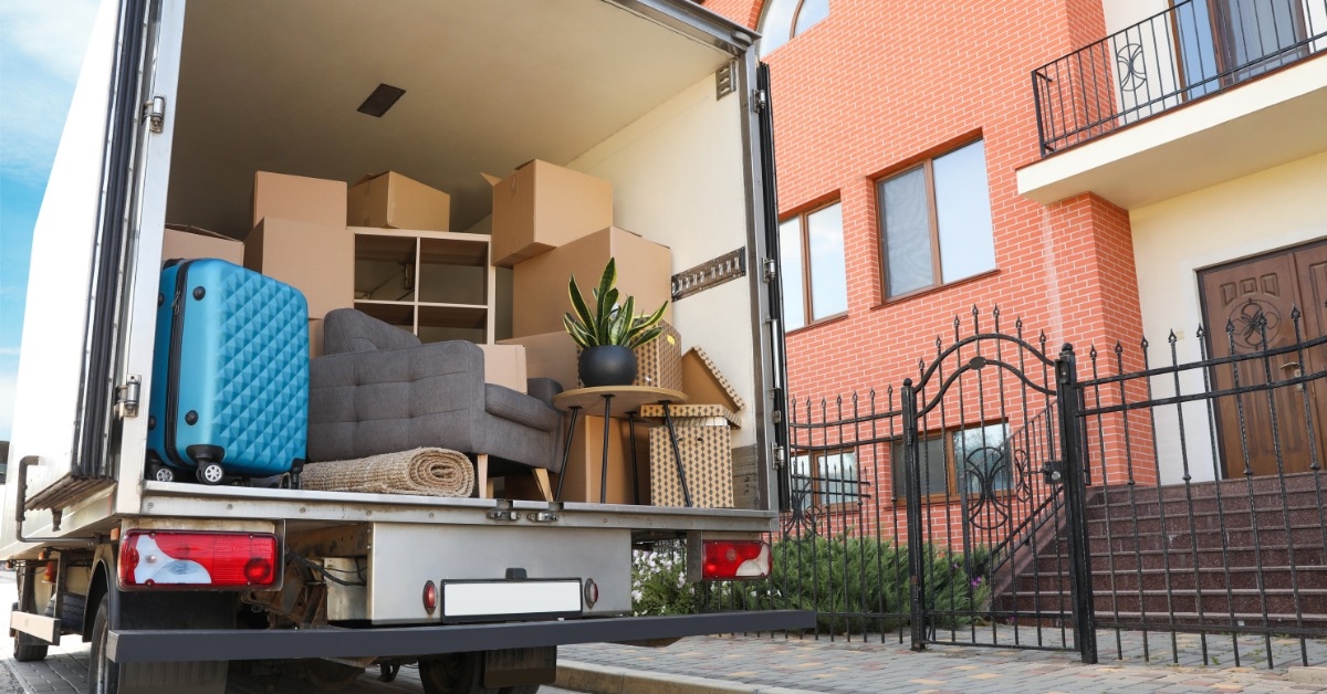 van full of moving boxes outside apartment