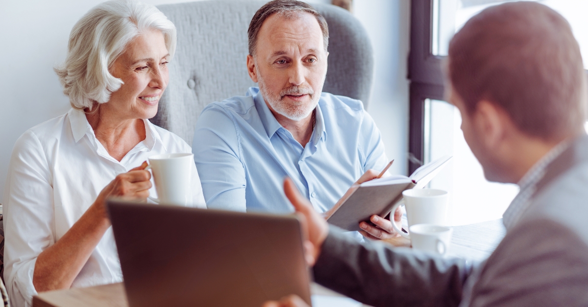 senior couple consulting with insurance agent