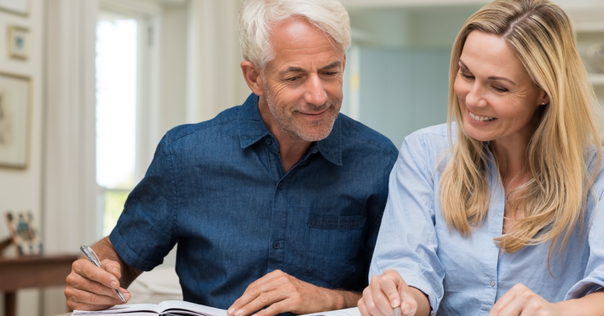 happy senior couple checking documents