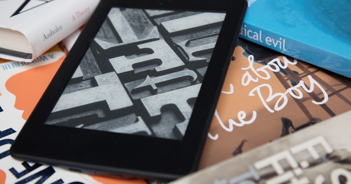 Amazon Kindle e-book reader on the pile of books