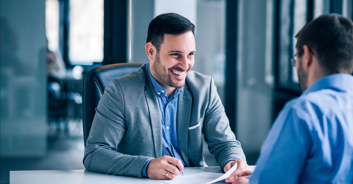 male client signing document on a meeting with real estate agent