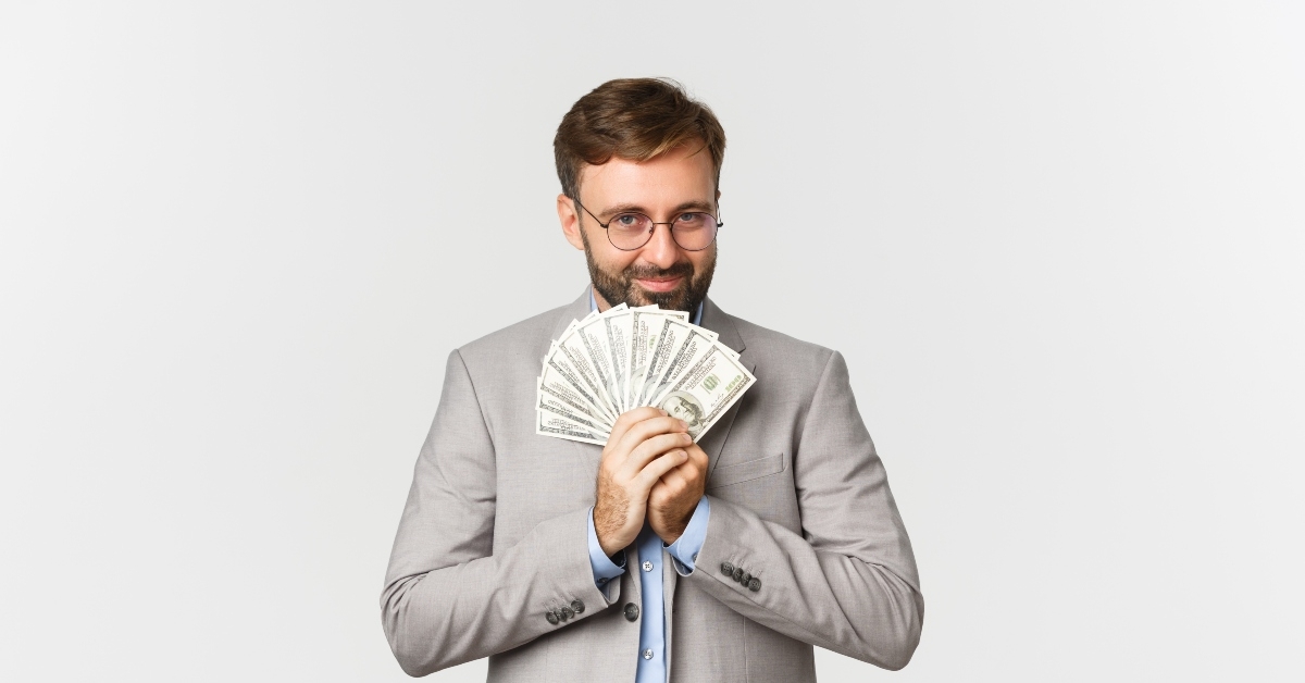 businessman with beard holding money