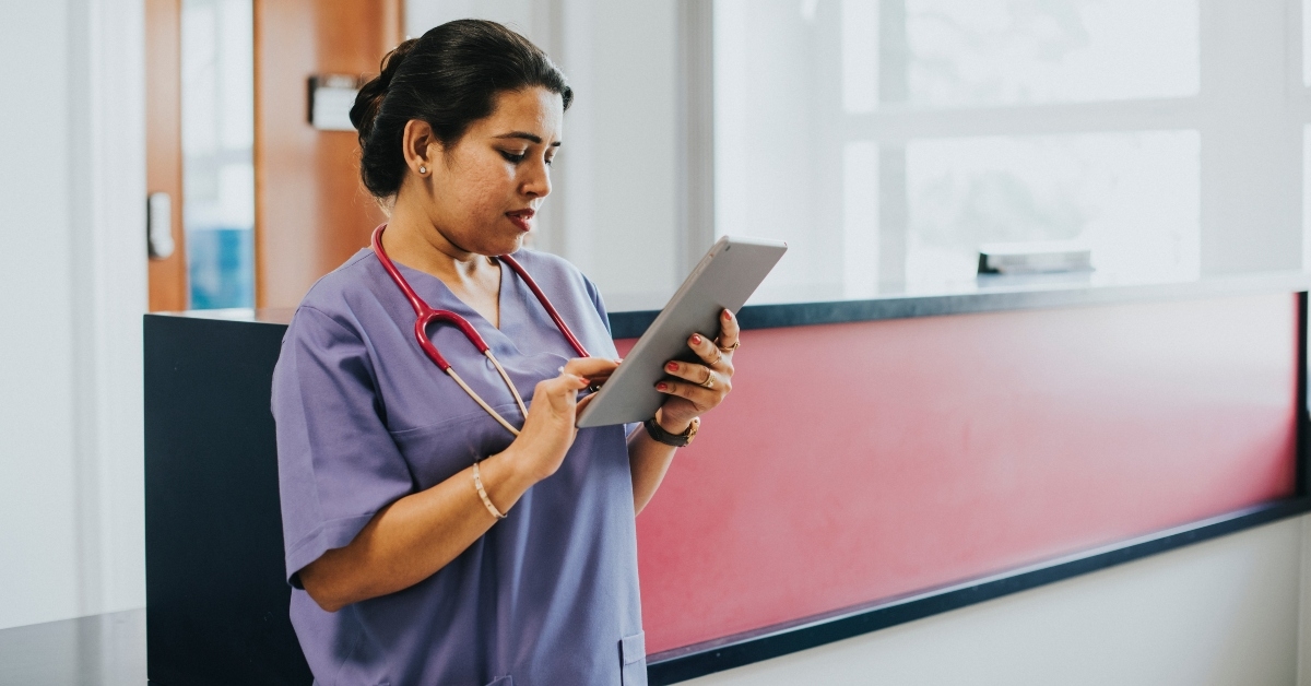 female nurse checking the schedule on a tablet