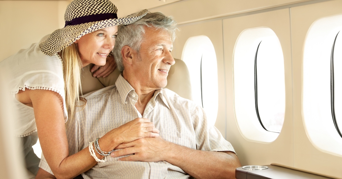 senior couple on an airplane looking out the window