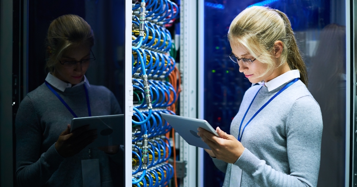 woman checking data on digital tablet while working with supercomputer