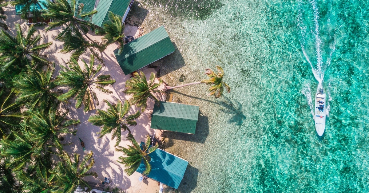 Tobacco Caye with palm trees and bungalows in the Belize Barrier Reef