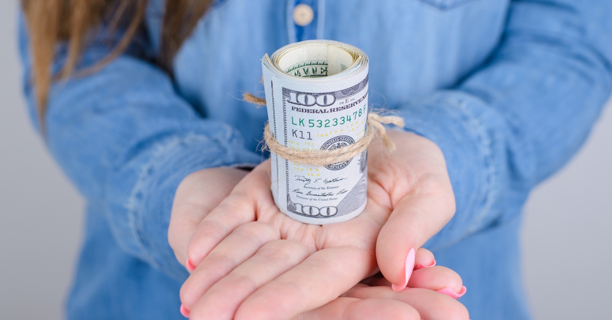 woman with long pink manicure advertising a lot of money