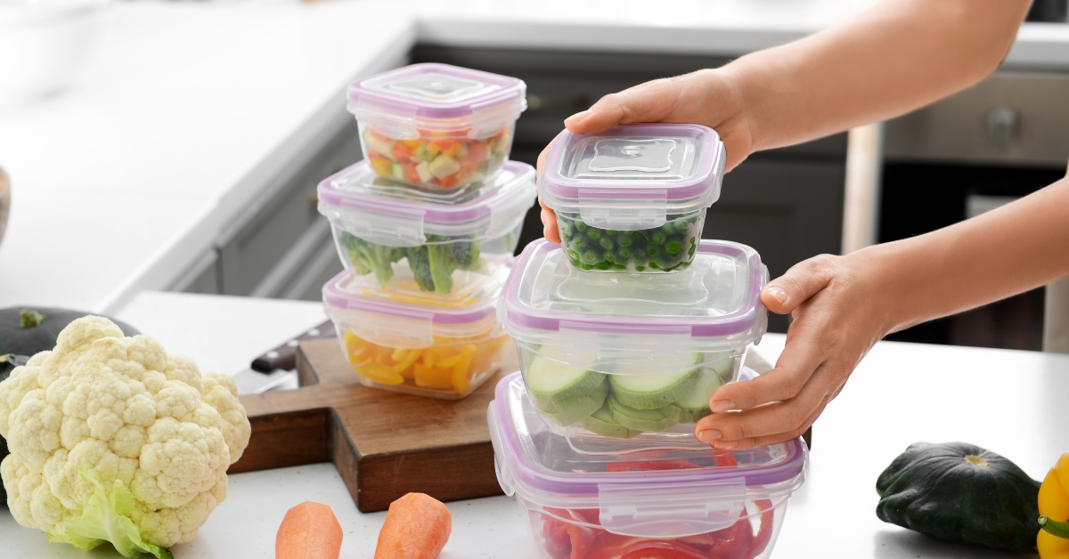 holding stack of plastic containers