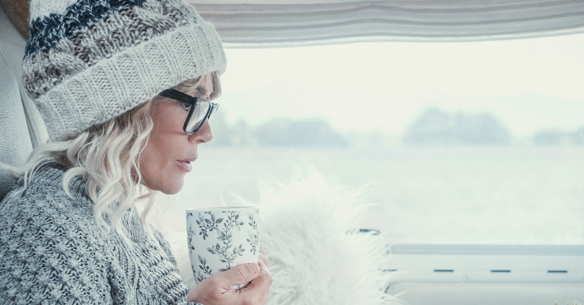 senior woman thinking about something while holding a cup 