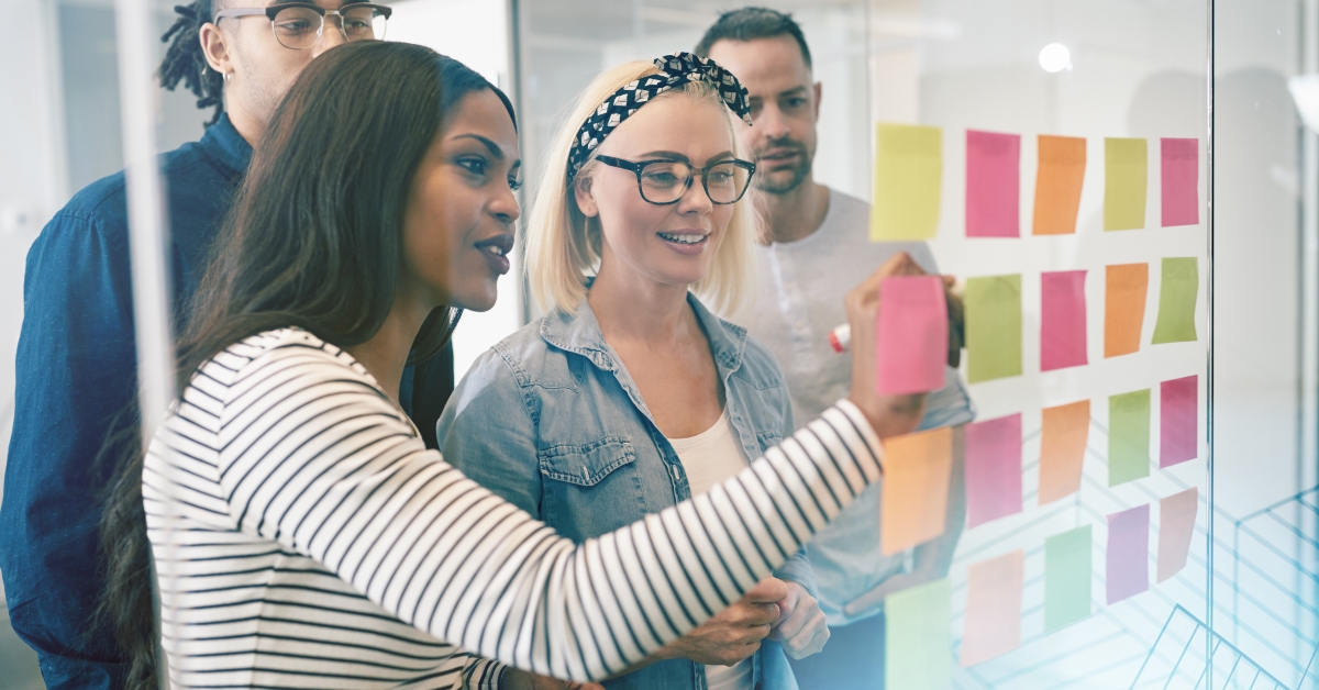 coworkers brainstorming with sticky notes in an office