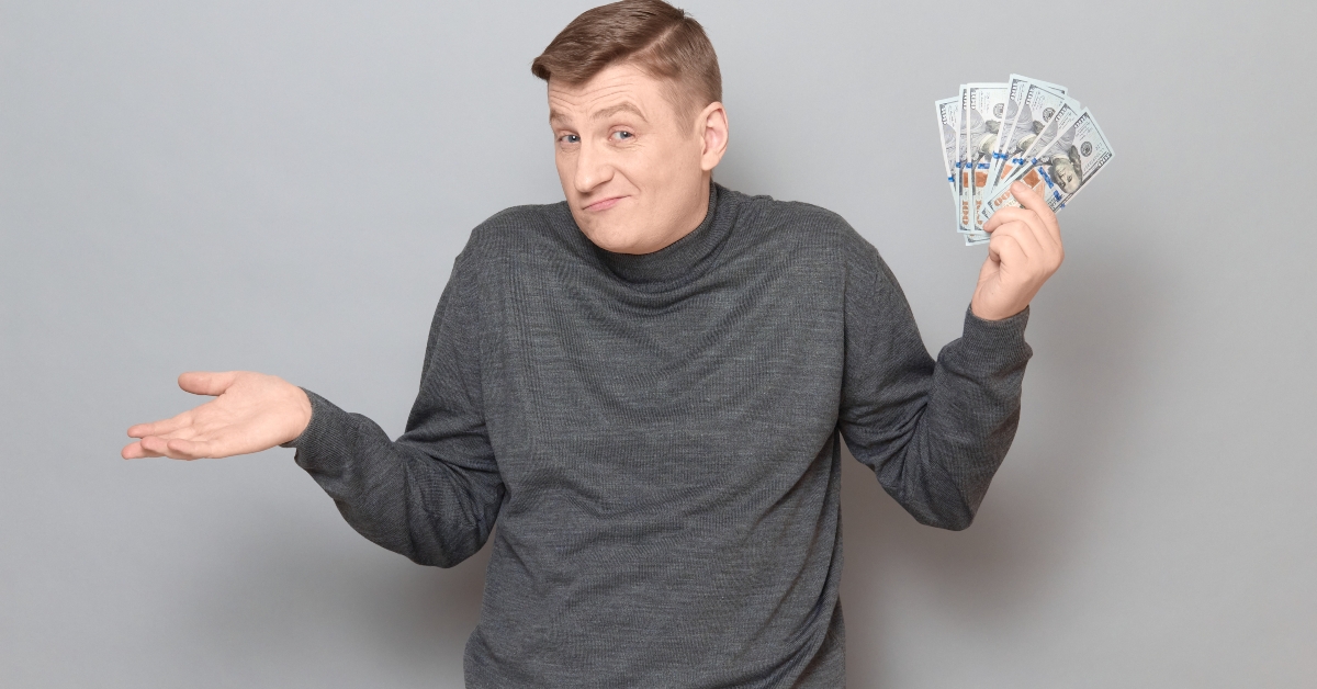 man holding bunch of US dollars