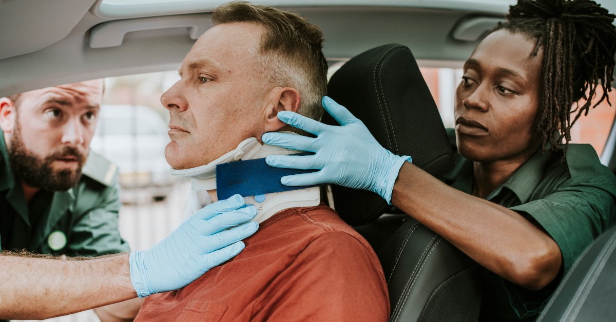 paramedic placing a cervical collar to an injured man