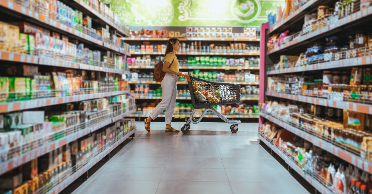 woman with shopping between store shelf