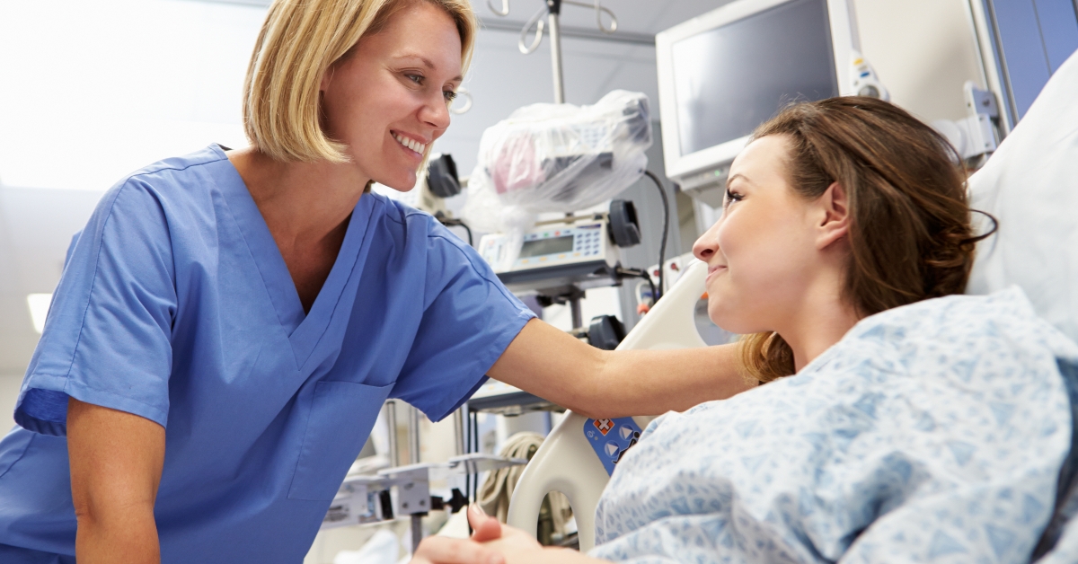 young female patient talking to nurse in emergency room