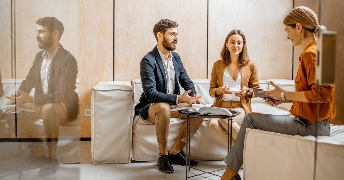 couple talking with woman as sales manager