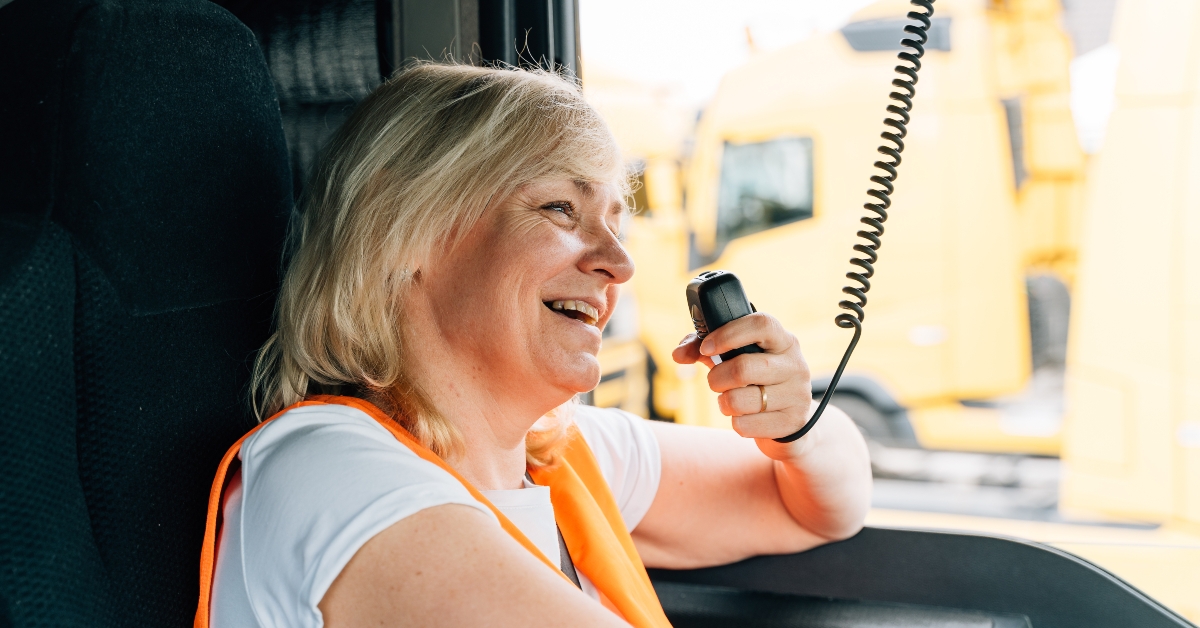 woman truck driver talking by radio inside the cabin
