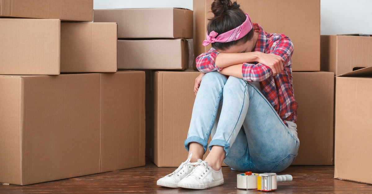 girl moving to new place sitting crying exhausted