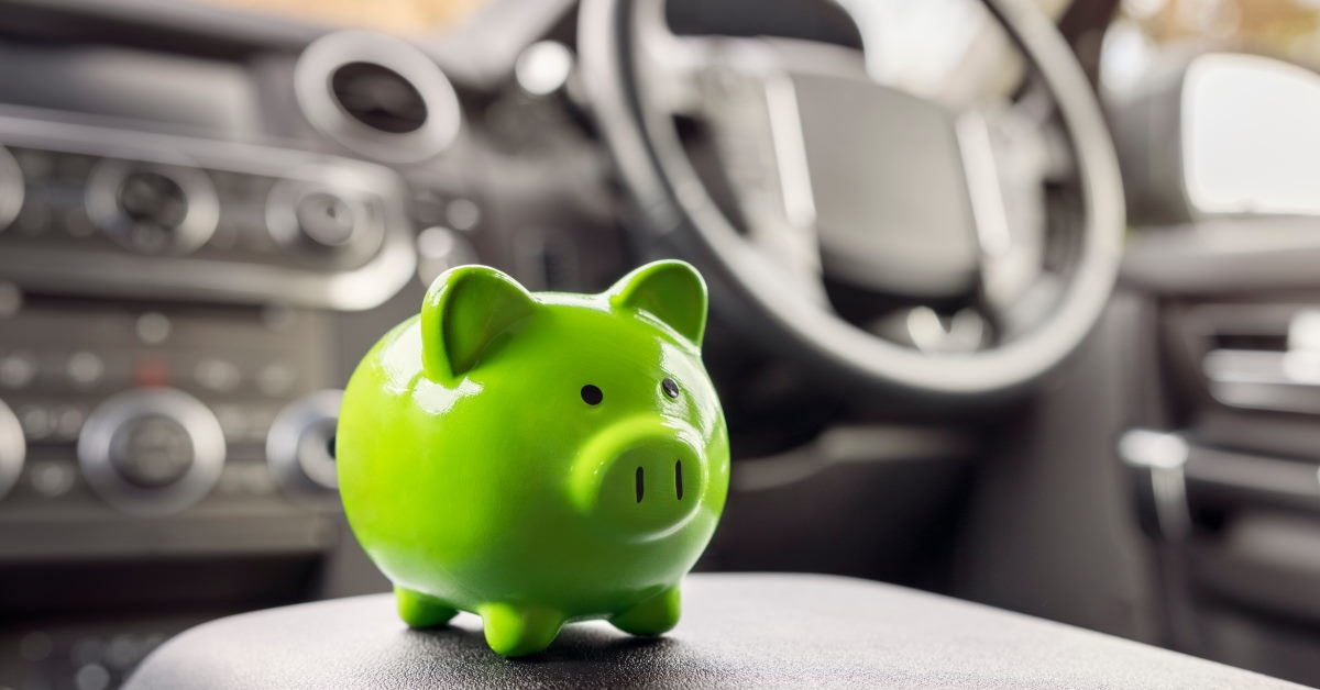 tiny green piggy bank in car during day time