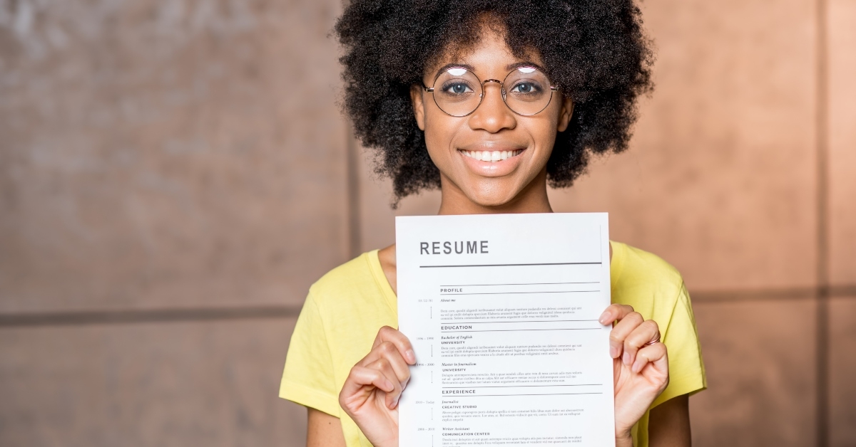 woman holding resume document indoors